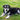 Elderly mixed breed dog relaxing on lush green grass in a sunny outdoor setting.